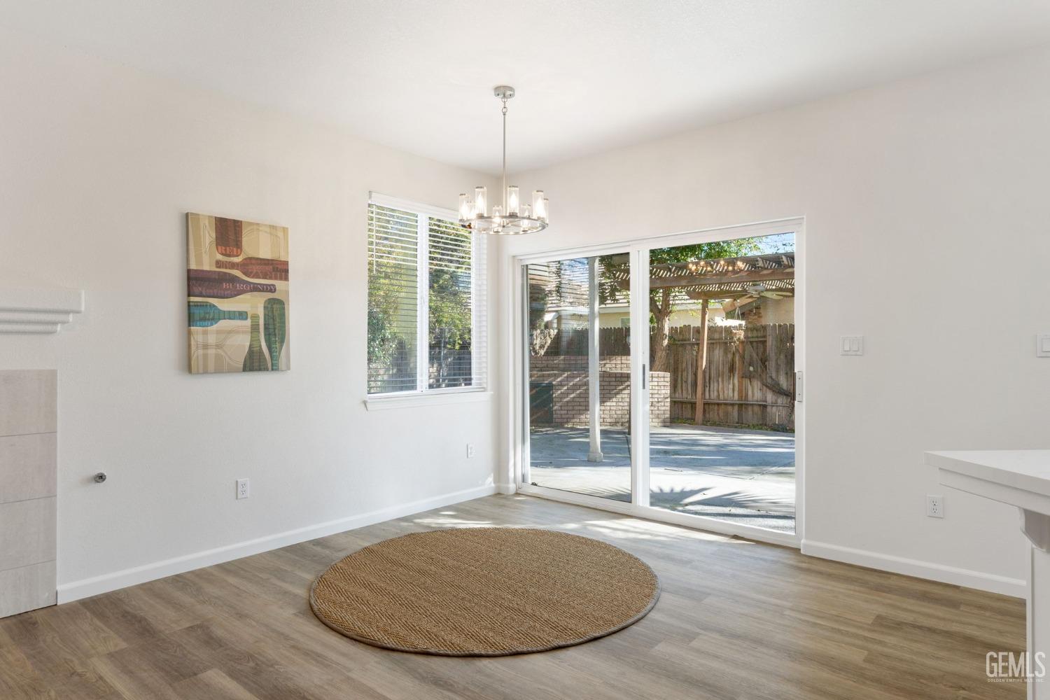 Undisclosed Address Bakersfield, CA 93311 - Photo 19 of 52 an empty room with wooden floor and windows