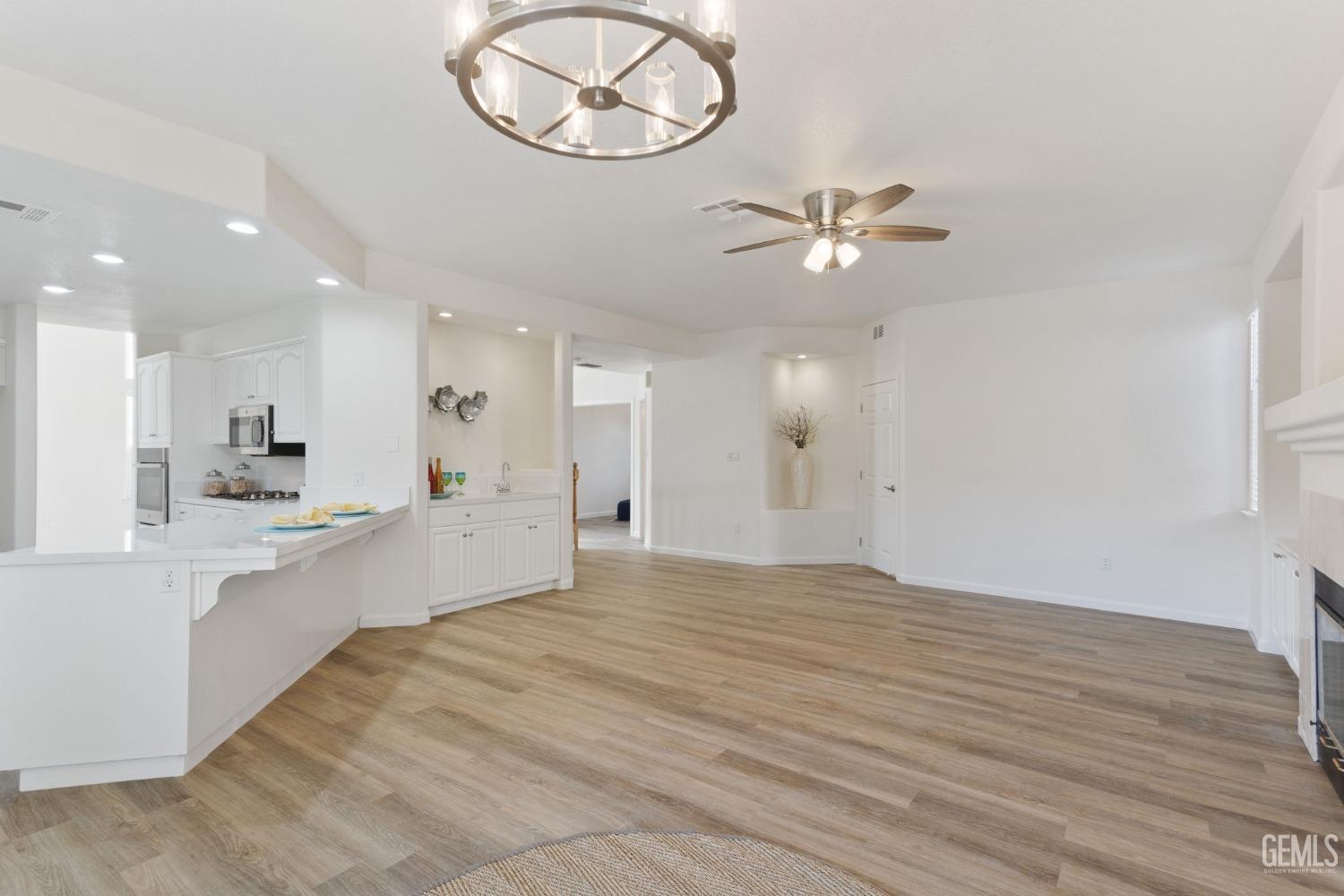 Undisclosed Address Bakersfield, CA 93311 - Photo 20 of 52 a view of a kitchen with an oven and wooden floor