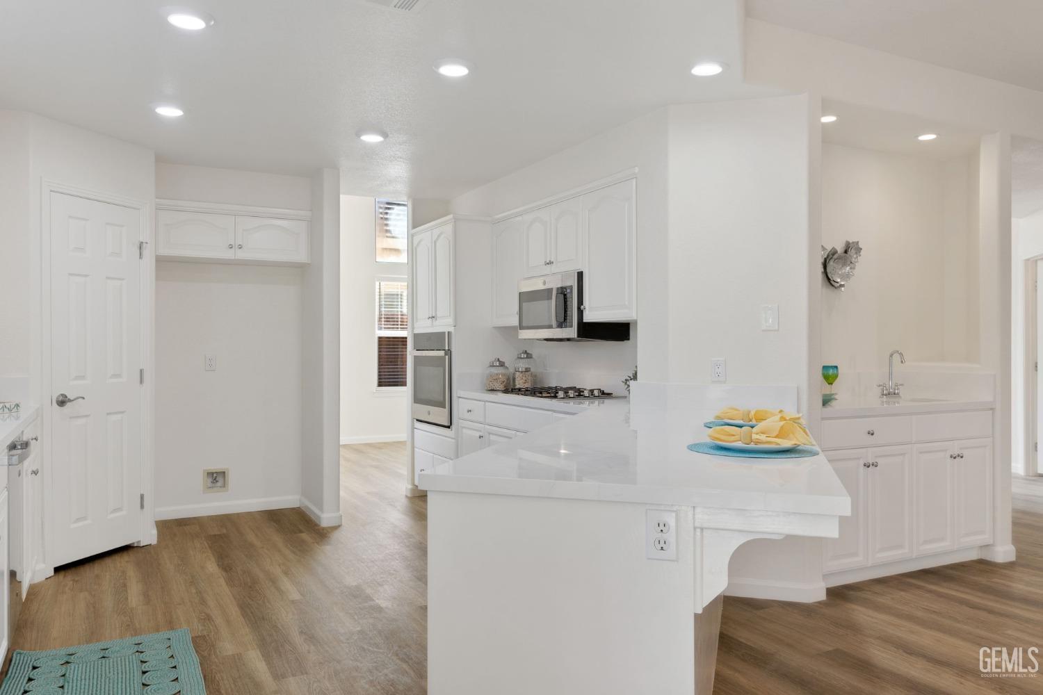 Undisclosed Address Bakersfield, CA 93311 - Photo 25 of 52 a kitchen with refrigerator and microwave