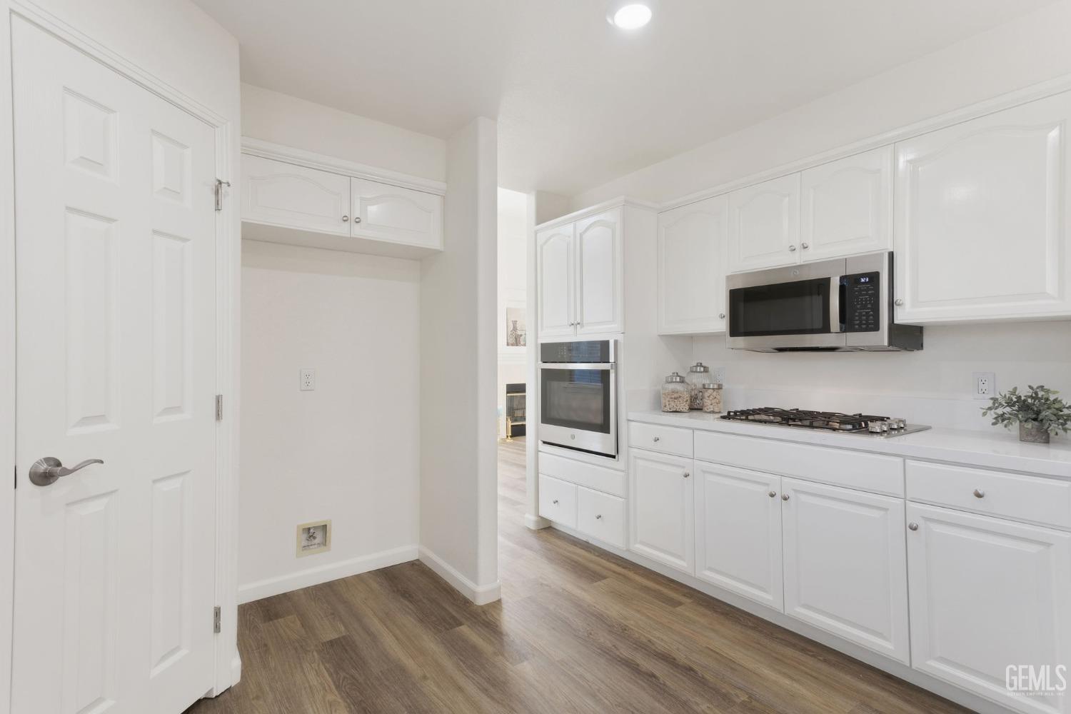 Undisclosed Address Bakersfield, CA 93311 - Photo 26 of 52 a kitchen with granite countertop white cabinets and stainless steel appliances