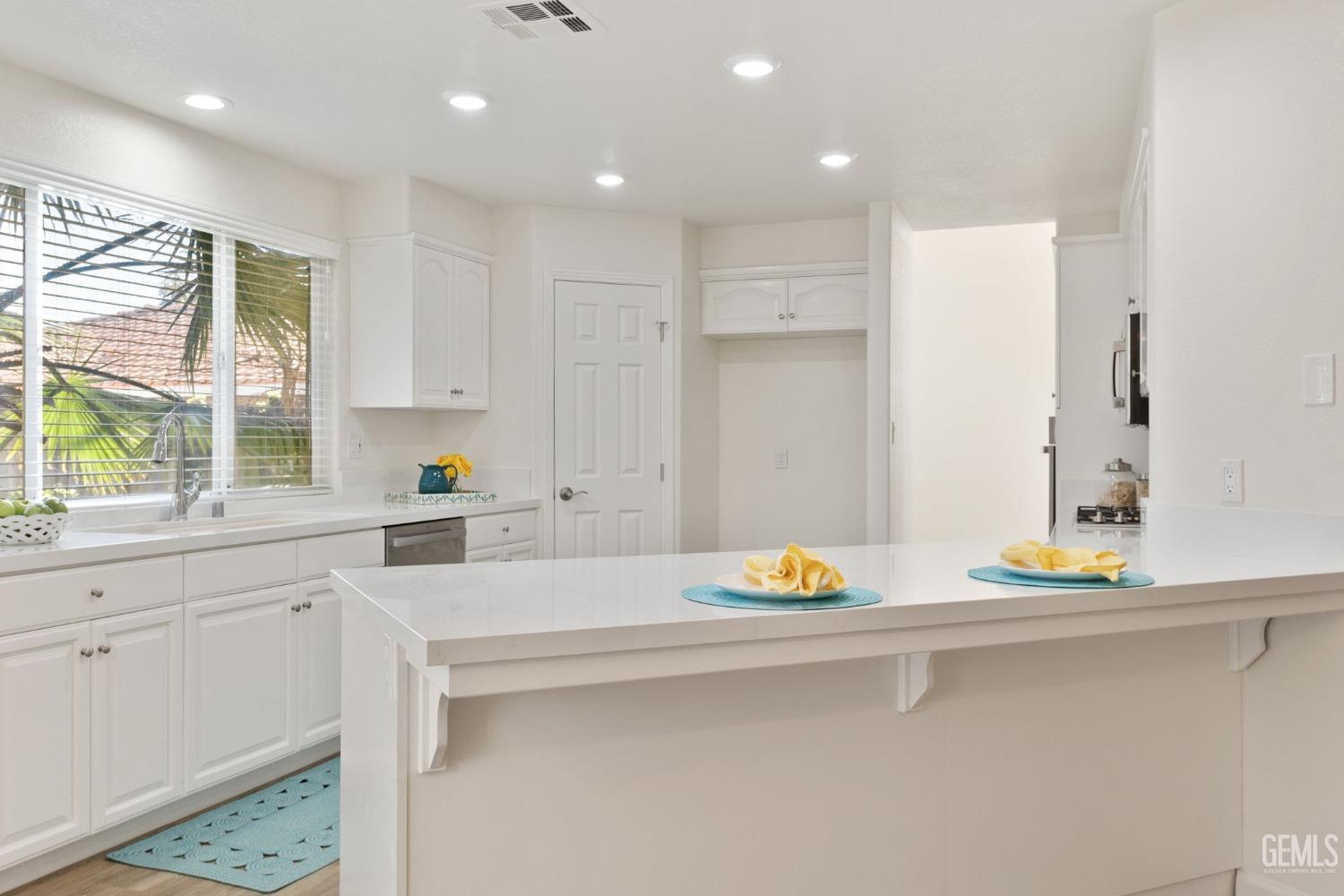 Undisclosed Address Bakersfield, CA 93311 - Photo 28 of 52 a kitchen with a sink white cabinets and a window