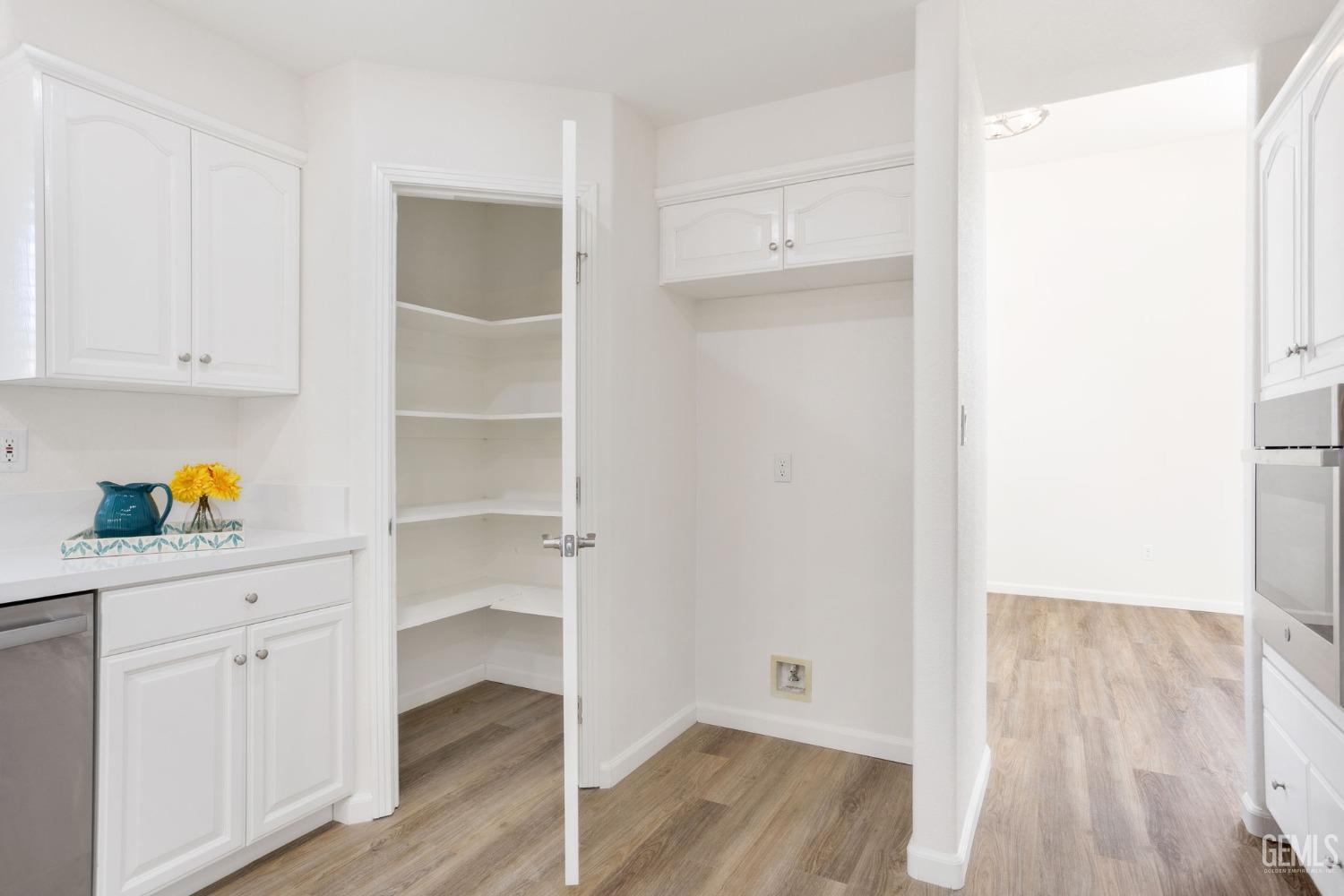 Undisclosed Address Bakersfield, CA 93311 - Photo 31 of 52 a hallway with cabinet with wooden floor