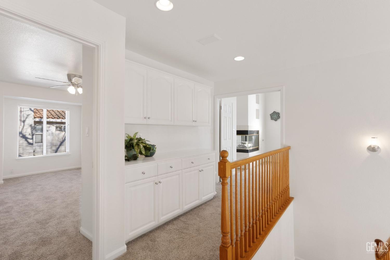 Undisclosed Address Bakersfield, CA 93311 - Photo 34 of 52 a hallway with cabinets and wooden floor