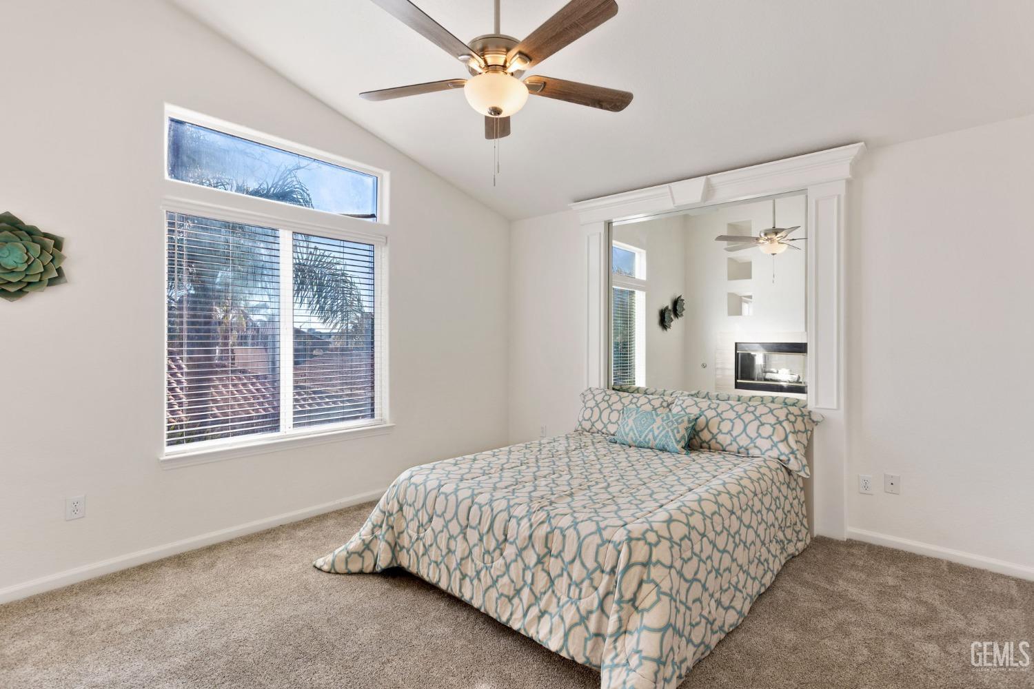Undisclosed Address Bakersfield, CA 93311 - Photo 35 of 52 a bedroom with a large bed and a chandelier fan