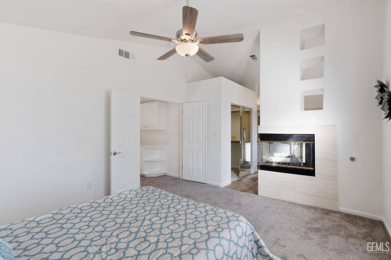 Undisclosed Address Bakersfield, CA 93311 - Photo 37 of 52 a bedroom with a bed and a chandelier