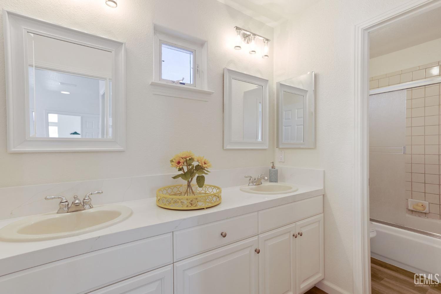 Undisclosed Address Bakersfield, CA 93311 - Photo 44 of 52 a bathroom with double vanity sinks and a mirror
