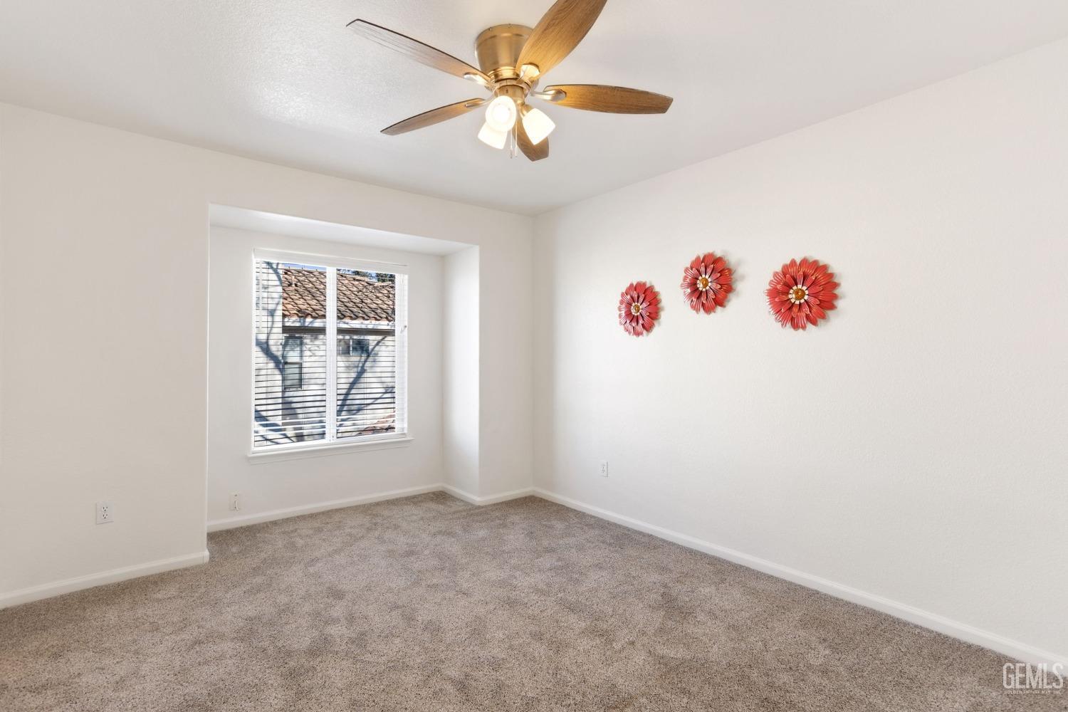 Undisclosed Address Bakersfield, CA 93311 - Photo 45 of 52 an empty room with windows and fan