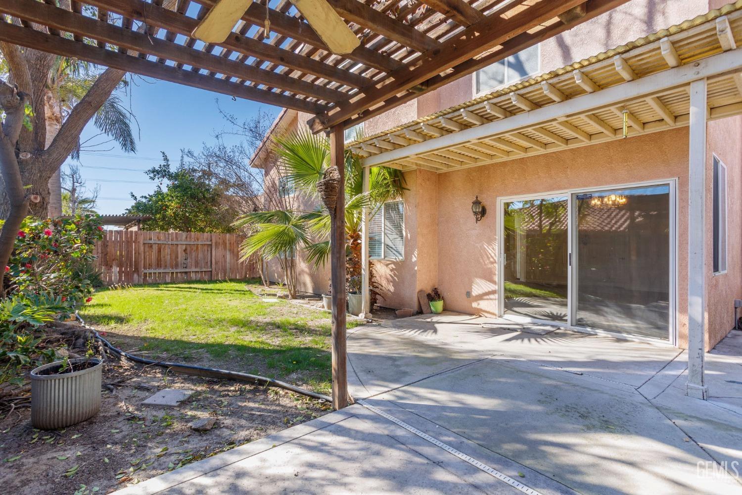 Undisclosed Address Bakersfield, CA 93311 - Photo 48 of 52 a view of a porch with a table and chairs and potted plants