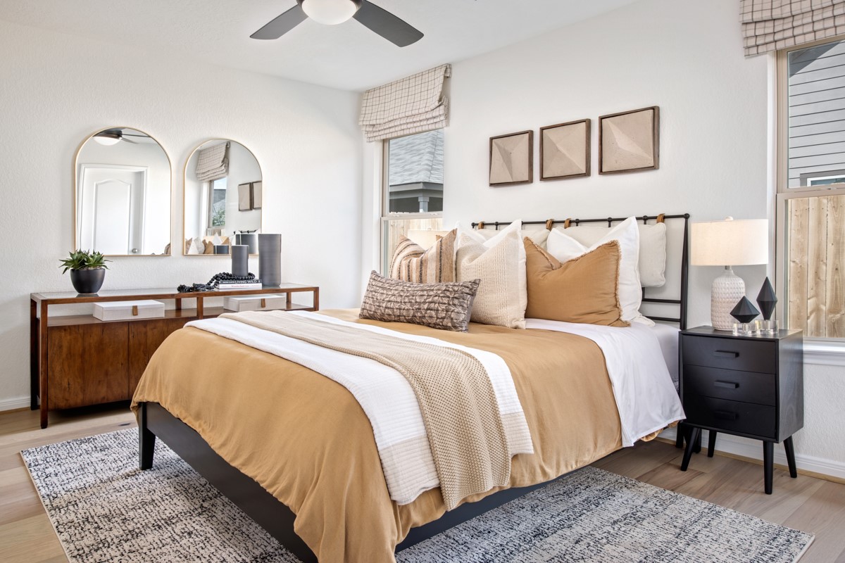 Relax and recharge in this stunning primary suite! Featuring engineered wood flooring, neutral-toned walls, high ceilings, ceiling fan, and large windows that fill the room with natural light.