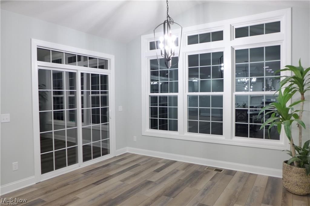 32028 Chestnut Ridge Road North Ridgeville, OH 44039 - Photo 19 of 39 Unfurnished room with a notable chandelier and hardwood / wood-style flooring