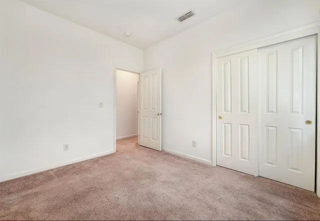 an empty room with a empty space and windows