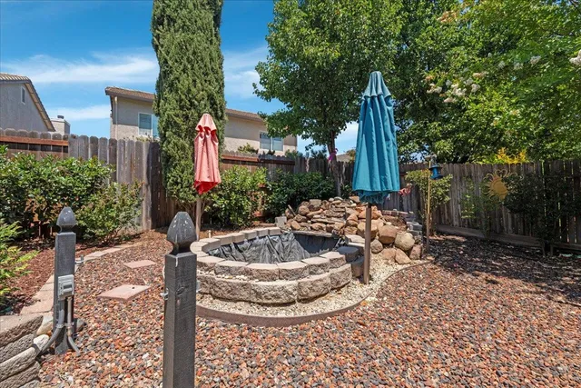 a view of a house with backyard and sitting area