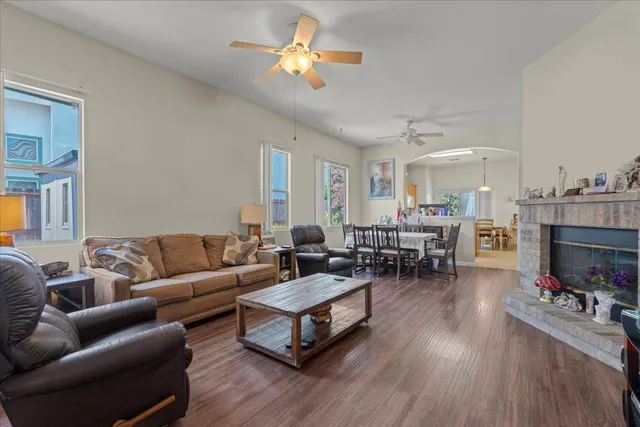 a living room with furniture a fireplace and a flat screen tv