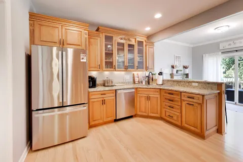 a kitchen with a refrigerator and a sink