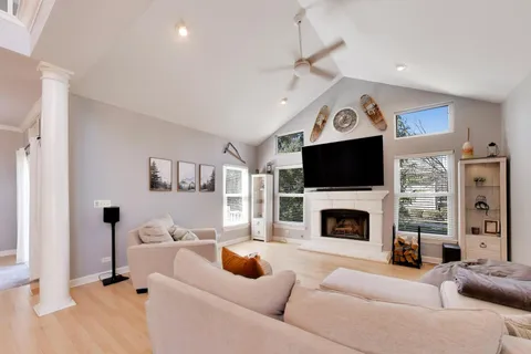 a living room with furniture and a chandelier