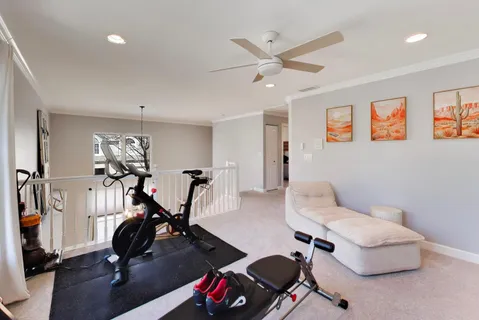 a bedroom with furniture and a flat screen tv