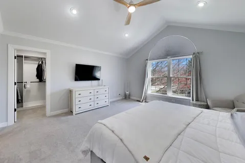 a spacious bedroom with a bed and a window