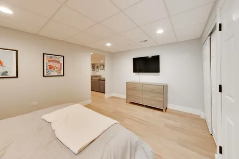 a spacious bedroom with a bed and a window
