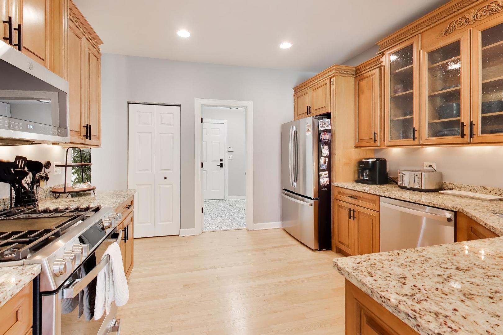 741 Juniper Lane Lake In The Hills, IL 60156 - Photo 10 of 43 a kitchen with stainless steel appliances granite countertop a refrigerator and a stove top oven