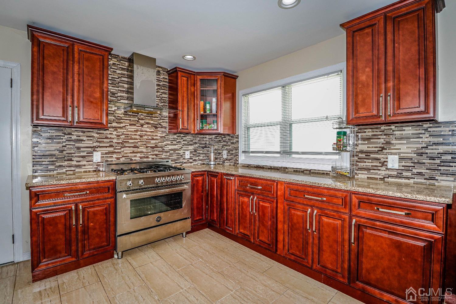 198 Carter Road Princeton, NJ 08540 - Photo 3 of 38 a kitchen with stainless steel appliances granite countertop wooden cabinets a sink and dishwasher with wooden floor