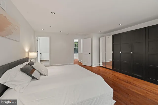 a spacious bedroom with a bed and a shower