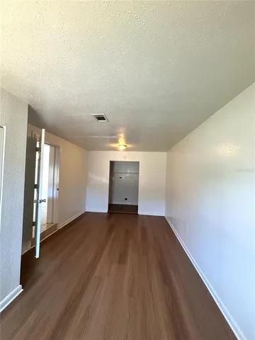 a view of a room with wooden floor and staircase