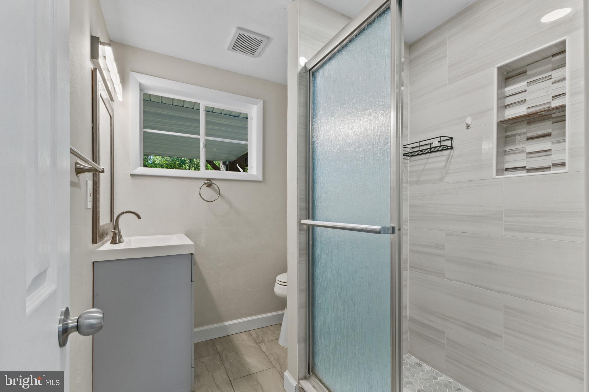 403 West Poplar Road Sterling, VA 20164 - Photo 18 of 25 Modern bathroom with natural light.