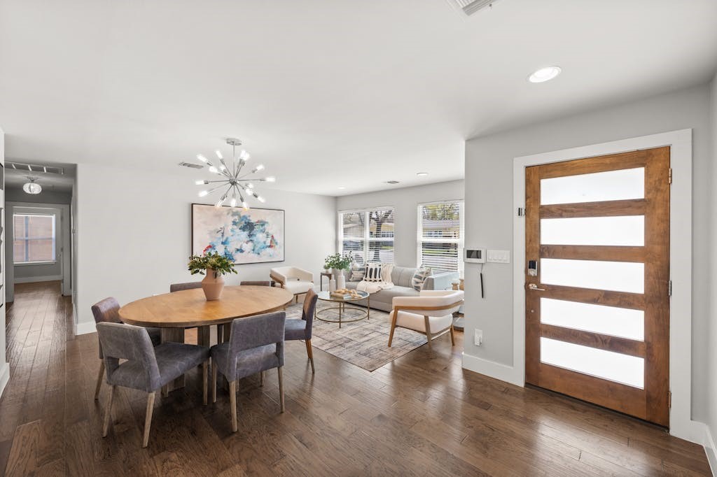 a view of a dining room with furniture and wooden floor