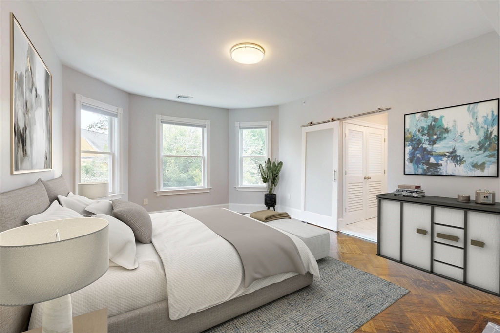 61 Charlotte Street, Unit 2 Boston, MA 02121 - Photo 12 of 36 a spacious bedroom with a bed and window