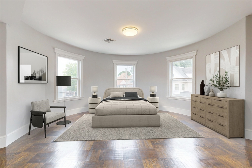 61 Charlotte Street, Unit 2 Boston, MA 02121 - Photo 17 of 36 a bedroom with a bed and wooden floor