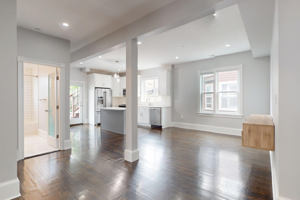 61 Charlotte Street, Unit 2 Boston, MA 02121 - Photo 2 of 36 a view of empty room with wooden floor and windows