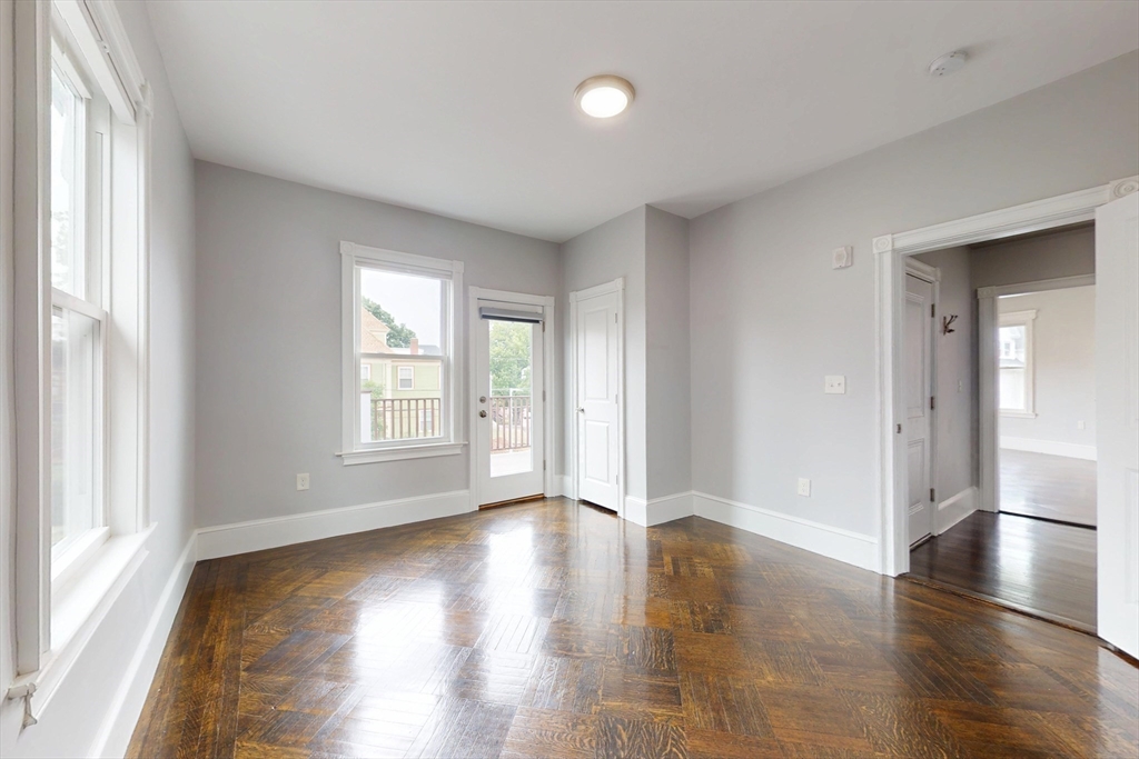 61 Charlotte Street, Unit 2 Boston, MA 02121 - Photo 21 of 36 a view of an empty room with wooden floor and a window
