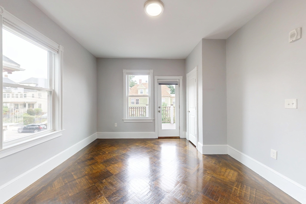 61 Charlotte Street, Unit 2 Boston, MA 02121 - Photo 22 of 36 a view of an empty room with wooden floor and a window