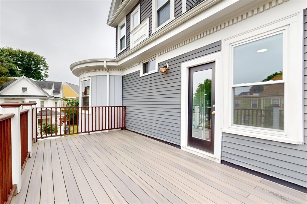 61 Charlotte Street, Unit 2 Boston, MA 02121 - Photo 23 of 36 a view of a house with a deck