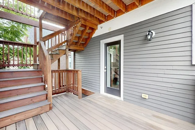a view of outdoor space with wooden floor and stairs