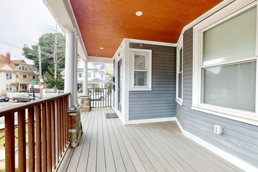 61 Charlotte Street, Unit 2 Boston, MA 02121 - Photo 30 of 36 a view of a balcony with wooden floor and fence