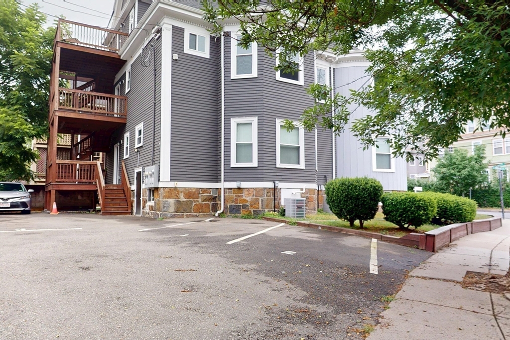 61 Charlotte Street, Unit 2 Boston, MA 02121 - Photo 31 of 36 a view of a building with a car park front of house