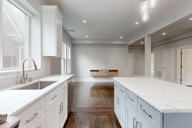 a kitchen that has a sink and a stove