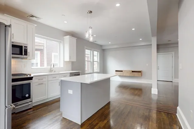 a kitchen with a sink stainless steel appliances and cabinets