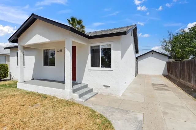a view of a house with wooden fence and large windows