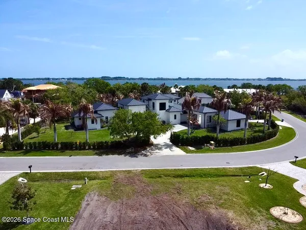 a aerial view of a house with garden space and a lake view