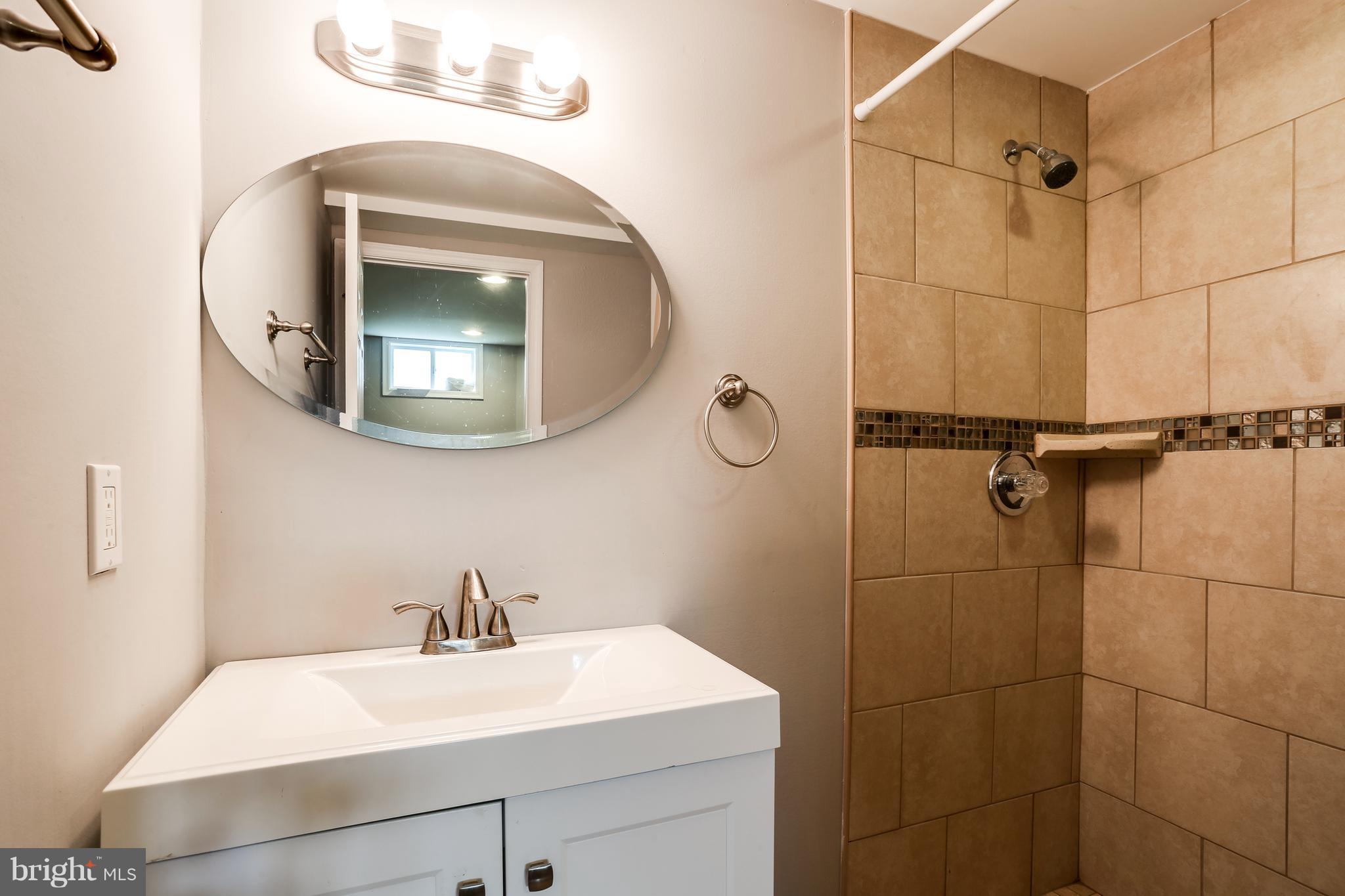 19 Millgate Road Owings Mills, MD 21117 - Photo 25 of 30 a bathroom with a sink mirror and vanity