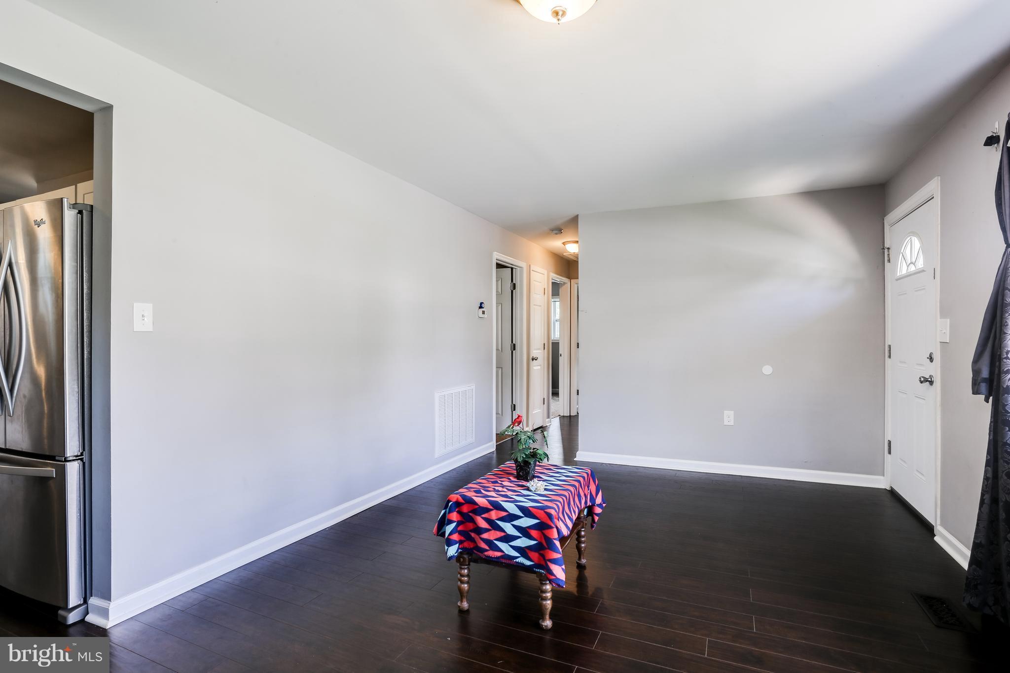 19 Millgate Road Owings Mills, MD 21117 - Photo 6 of 30 a living room with furniture and a chandelier