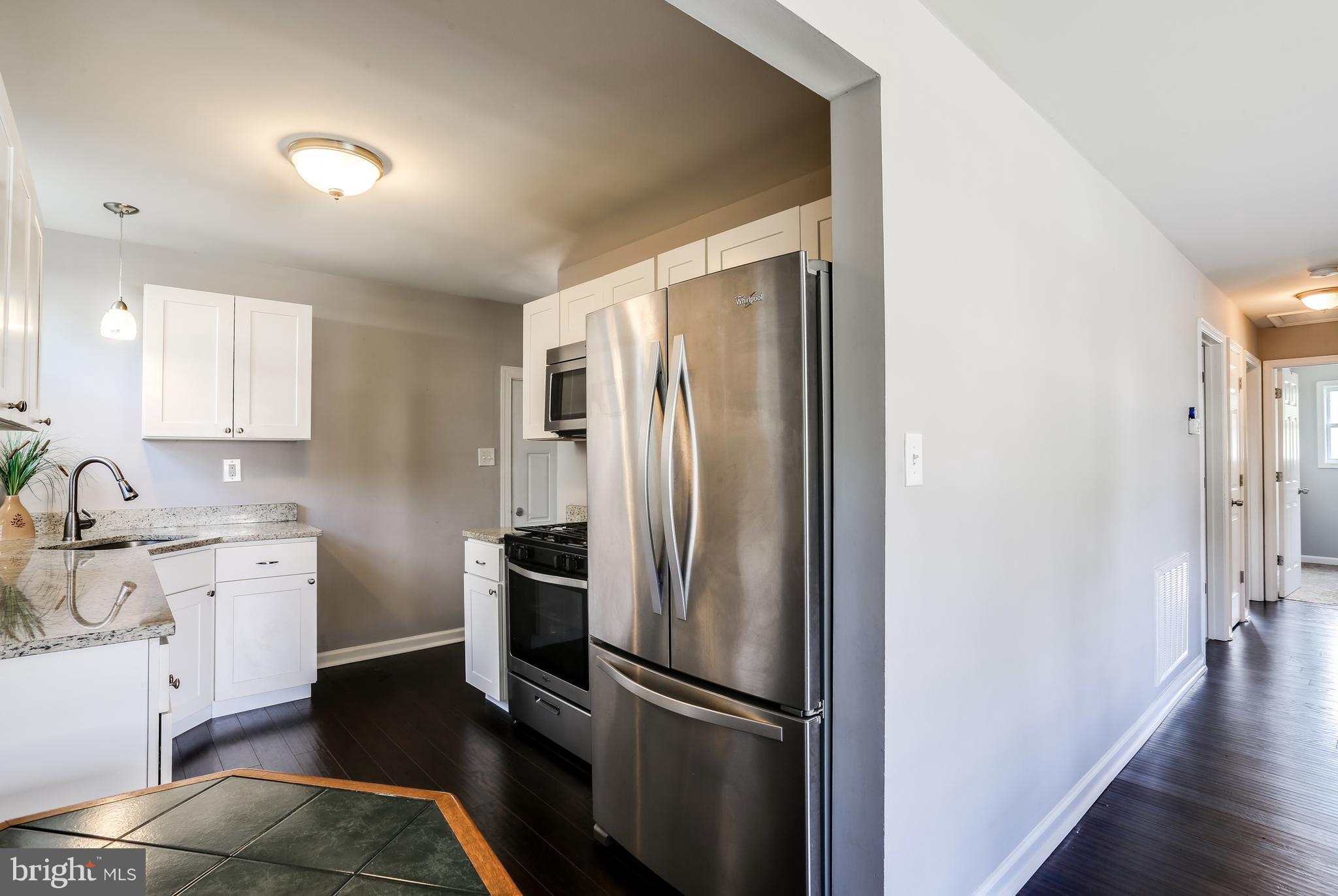 19 Millgate Road Owings Mills, MD 21117 - Photo 8 of 30 a kitchen with stainless steel appliances granite countertop a refrigerator and a sink