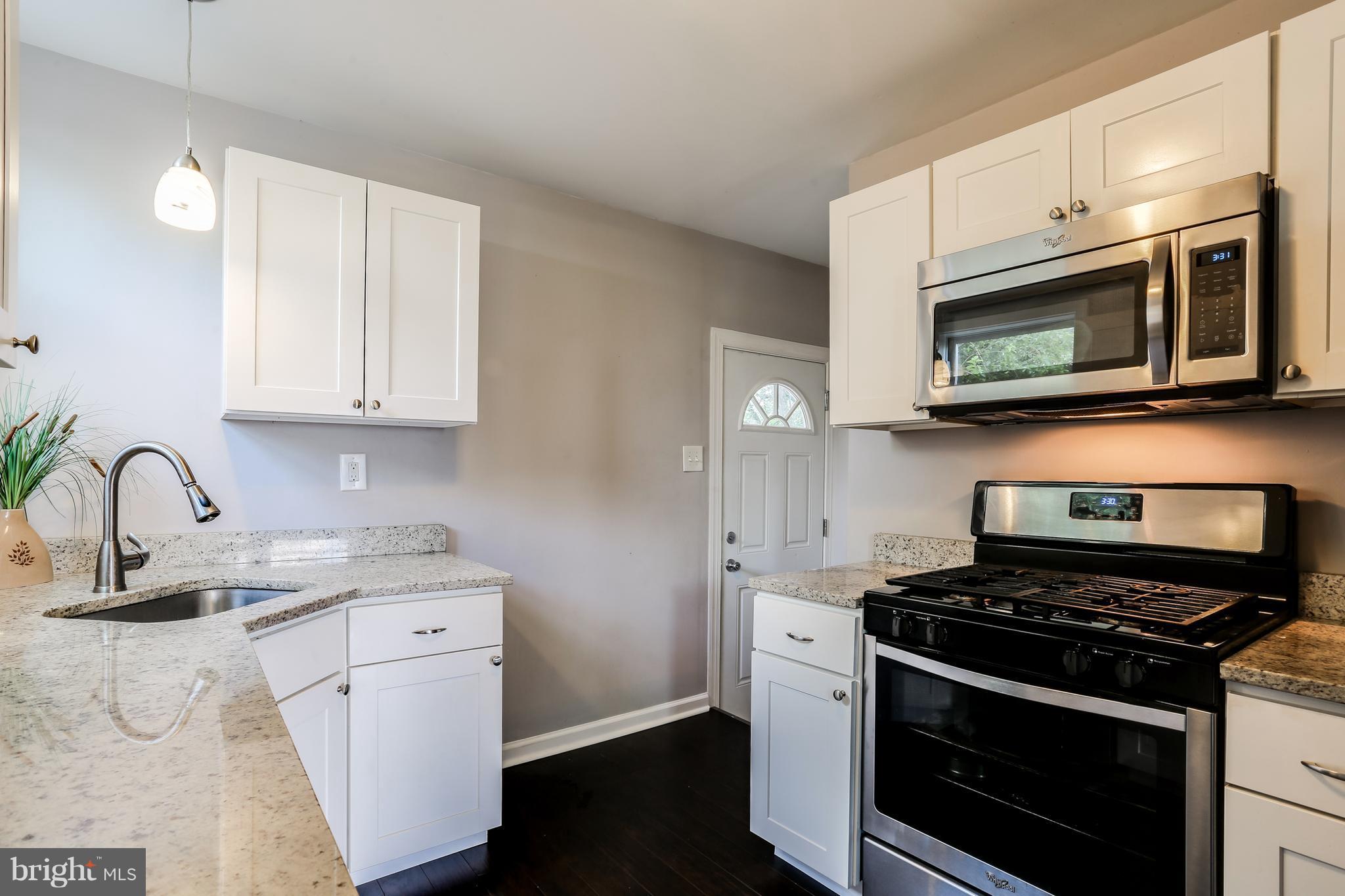 19 Millgate Road Owings Mills, MD 21117 - Photo 10 of 30 a kitchen with stainless steel appliances granite countertop a stove microwave and sink