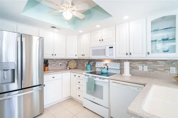 a kitchen with stainless steel appliances a refrigerator and cabinets