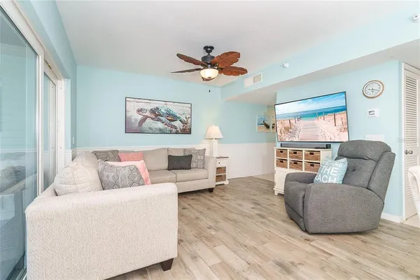 a view of a balcony with couch and wooden floor