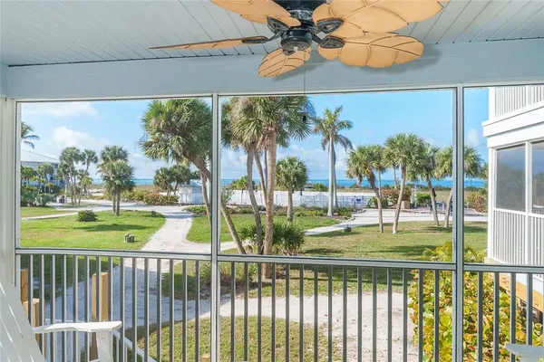 a bedroom with a bed a chandelier and a window