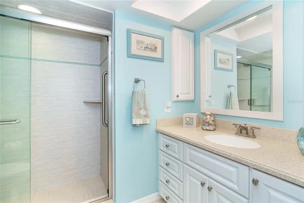 a bathroom with a shower and a sink