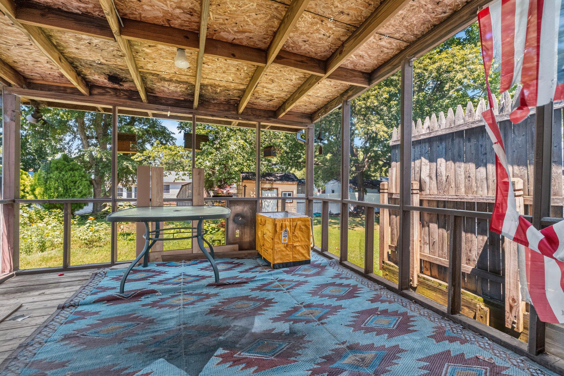 7738 Notley Road Pasadena, MD 21122 - Photo 23 of 25 Screened porch with garden views.